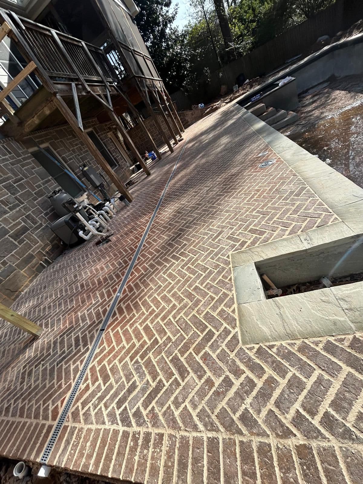 Brick pool deck with spa and patio area in North Atlanta, GA by Escobar Masonry & Hardscapes