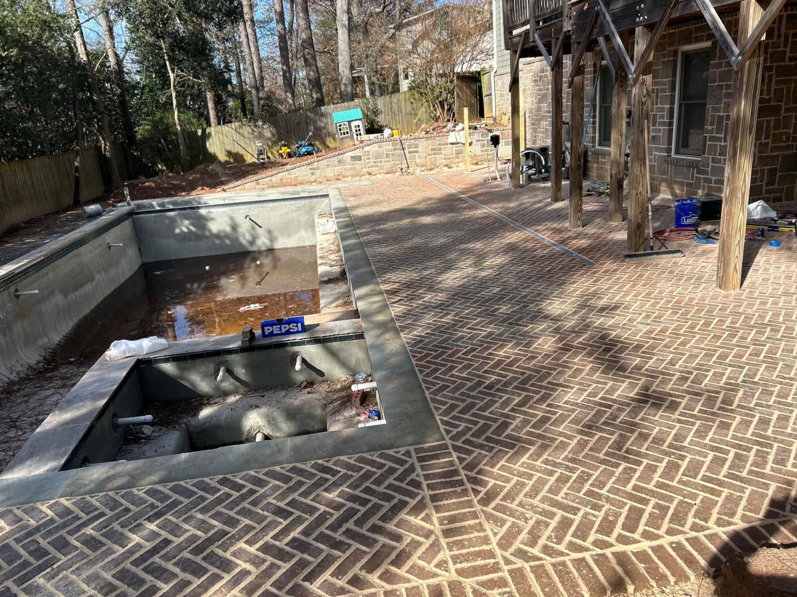 Brick pool deck with herringbone pattern in North Atlanta, GA by Escobar Masonry & Hardscapes