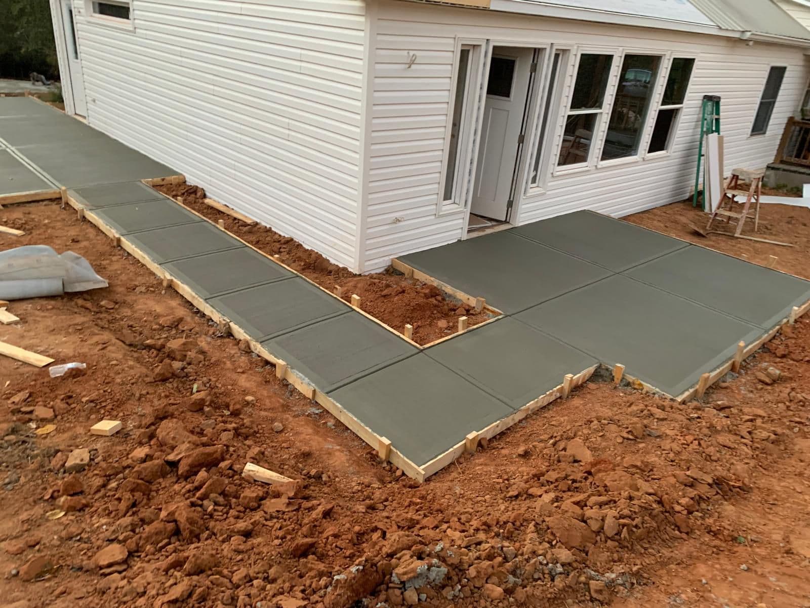 Concrete patio and side walk connection in North Atlanta, GA by Escobar Masonry & Hardscapes