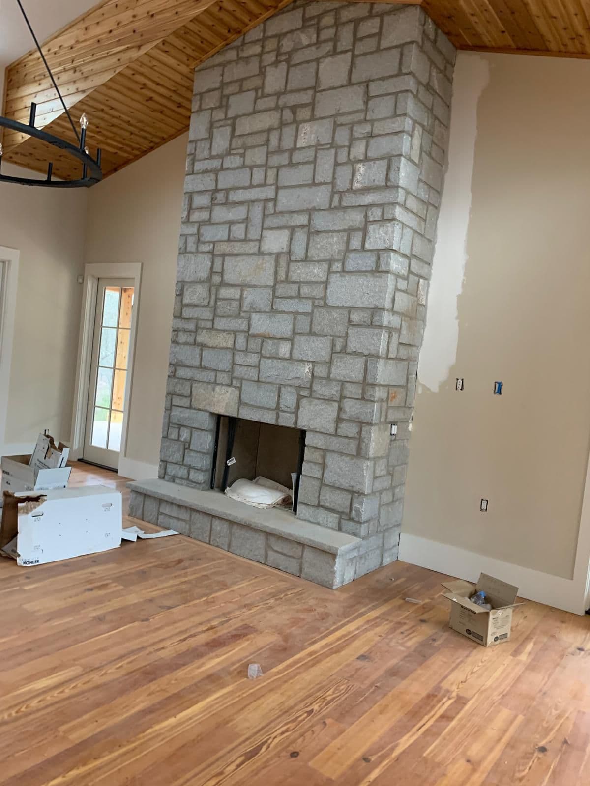Stone fireplace in finished living room in North Atlanta, GA by Escobar Masonry & Hardscapes