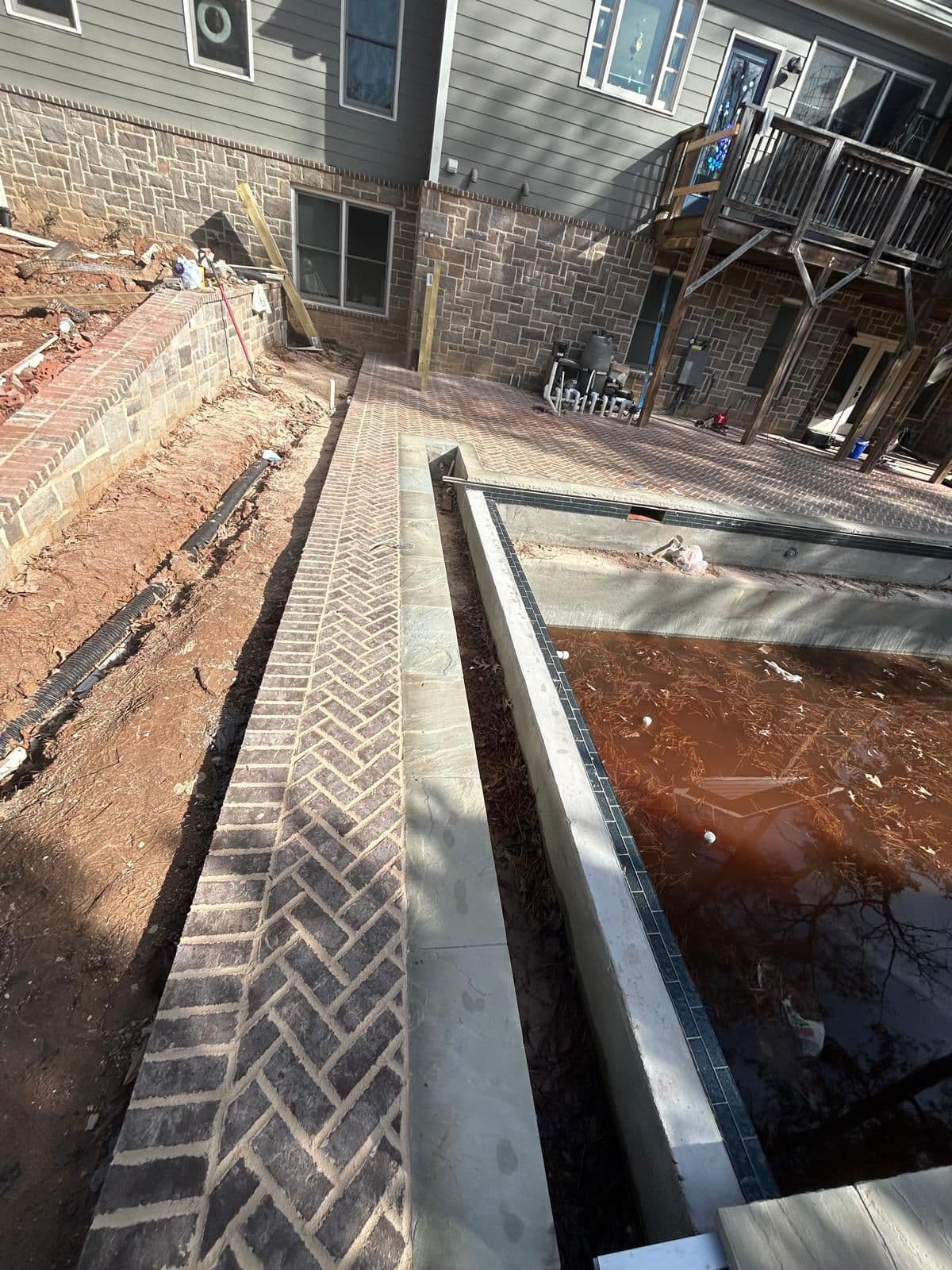 Travertine pool deck and outdoor kitchen in North Atlanta by Escobar Masonry & Hardscapes